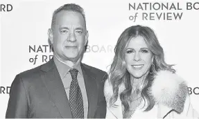  ?? DIA DIPASUPIL/ FILMMAGIC ?? Tom Hanks, left, and wife Rita Wilson were the first high- profile American celebritie­s to reveal their coronaviru­s diagnoses in March.