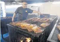  ?? TAIMY ALVAREZ/SOUTH FLORIDA SUN SENTINEL ?? Derrick McCray works the pit Tuesday at McCray’s Backyard Bar-B-Q in West Palm Beach. The resturant will cater multiple Super Bowl events.