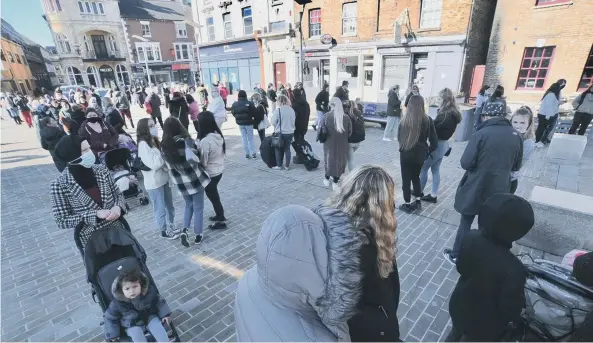  ??  ?? Shoppers queueing outside Queensgate on Monday morning.