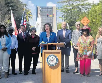  ?? MIKE STOCKER/SOUTH FLORIDA SUN SENTINEL ?? Speaker of the House Nancy Pelosi, with local officials and supporters, talks about the recently signed bipartisan infrastruc­ture bill while standing in front of the drawbridge on George Bush Boulevard in Delray Beach on Saturday.