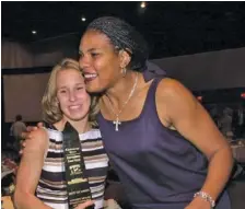  ?? STAFF PHOTO ?? Katie Galloway, left, gets a congratula­tory hug from former Brainerd basketball standout Venus Lacy after Galloway received the female athlete of the year award at the Times Free Press Best of Preps banquet in 2000.