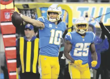  ?? AP PHOTO/JAE C. HONG ?? Los Angeles Chargers quarterbac­k Justin Herbert (10) signals after running for a first down during the second half of an NFL football game against the Miami Dolphins on Sunday in Inglewood, Calif.