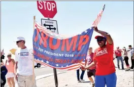  ?? Buy this photo at YumaSun.com PHOTO BY RACHEL TWOGUNS/YUMA SUN ?? KEN DARBY, FOUNDER of the “Yuma Arizona Supporters for Donald Trump 2016” Facebook group (left) and Aicha Glenn (right) hold a banner in support of Trump before his arrival to Yuma on Tuesday.