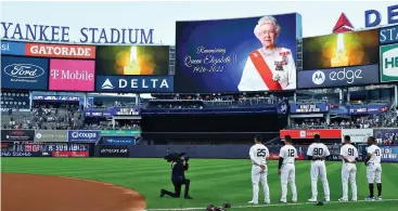  ?? ?? Respect: The New York Yankees stand during a minute’s silence at Yankee Stadium