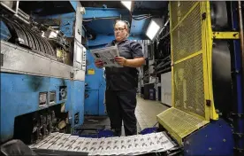  ?? TONY DEJAK PHOTOS / AP 2019 ?? Press operator Robin Yeager looks over the registrati­on of a copy of TheVindica­tor, in Youngstown, which shut down last year because of financial struggles. Its history is celebrated in a newbook.