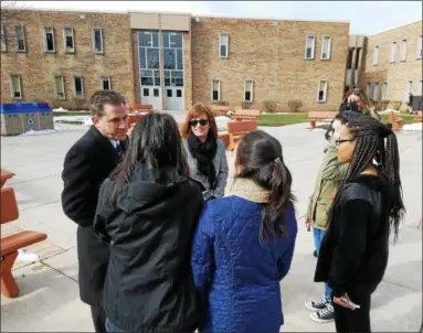  ?? PHOTOS BY DAN SOKIL — DIGITAL FIRST MEDIA ?? North Penn School Board President Tina Stoll, center, and Superinten­dent Curt Dietrich talk to students who organized a national walkout to protest gun violence on Wednesday.