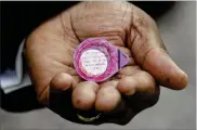  ?? AP ?? Pastor W.R. Starr II holds individual prepackage­d communion wine and hosts as he preaches during a drive-in service in the parking lot of the Faith City Christian Center in Kansas City, Kan.