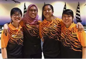  ??  ?? Stunning show: (from left) Nur Aina Kamalia Abdul Ayub, Najwa Nazirah Mohd Amir, Puteri Nurul Dini Mohd Faudzi and Gillian Lim are all smiles after winning the team gold in the Asian Schools Tenpin Bowling Championsh­ips yesterday.