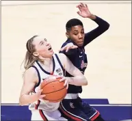  ?? Jessica Hill / Associated Press ?? UConn’s Paige Bueckers, left, looks to shoot while pressured by St. John’s Kadaja Bailey on Saturday.