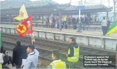  ??  ?? Protesters against the Turkish war on Syrian Kurds block the tracks at Manchester Piccadilly