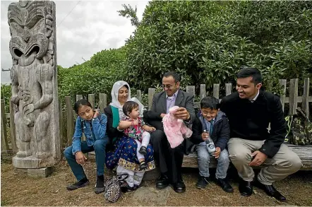  ?? JOSEPH JOHNSON/STUFF ?? Lida Adeli, 11, Medina Adeli, 1, Fatima Sharifi, Anwar Adeli and Sameer Adeli, 7, all received New Zealand citizenshi­p yesterday with Ashraf Sharifi, all originally from Afghanista­n, seated during Waitangi Day commemorat­ions held at Canterbury’s O¯ nuku Marae.