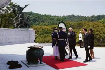  ?? Evan Vucci / Associated Press ?? President Biden places a wreath at Seoul National Cemetery. Biden said cooperatio­n between the United States and South Korea shows “our readiness to take on all threats together.”