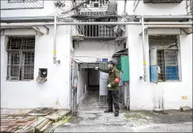  ?? CHINATOPIX VIA AP ?? A government worker sprays disinfecta­nt on a residentia­l building in Wuhan in central China’s Hubei Province, Tuesday, where the outbreak started.