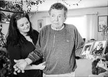  ?? JEFF MCINTOSH THE CANADIAN PRESS ?? Nelson Smith, father of Canadian death row inmate Ronald Smith, holds a 1980s photo of his son, as Ronald's daughter Carmen looks on in Red Deer, Alta., on March 22. Nelson Smith died less than three weeks later.