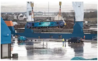  ?? DAVE MCALONE. ?? Direct Rail Services 88003 Genesis is off-loaded from the EemsliftNe­lli at Port of Workington on March 1. The dual-mode Class 88s could yet haul transPenni­ne passenger trains in place of Class 68s, according to franchise documents released by the...