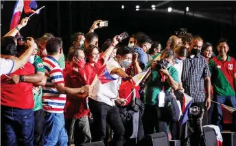  ?? ?? Marcos Jr (centre) greeting supporters during the last campaign rally ahead of the May 9 election, in Paranaque City, suburban Manila.