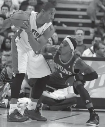  ?? STEVE RUSSELL/TORONTO STAR ?? Cavs guard Daniel Gibson, right, tries to stop Raps swingman Demar Derozan, who had 25 points Wednesday.