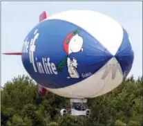  ??  ?? In this July 2, 2007, photo, the MetLife Snoopy Two blimp comes in for a landing at the Park Township Airport in Holland, Mich. Below right, Snoopy gets a star on the Hollywood Walk of Fame, in Los Angeles in 2015.