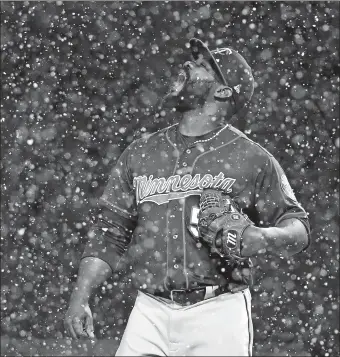  ?? GENE J. PUSKAR/AP PHOTO ?? Minnesota relief pitcher Fernando Rodney stands on the mound during a snow squall in the ninth inning of Wednesday’s game against the Pirates in Pittsburgh. The Twins won 7-3.