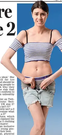  ??  ?? Squeeze: A model struggles to fit into a crop top and denim shorts