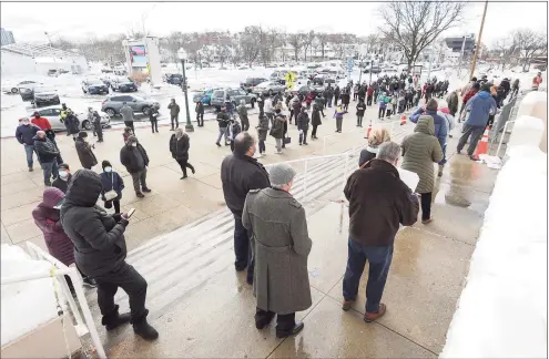  ?? John Meore / Associated Press ?? People with appointmen­ts for the COVID-19 vaccine wait outside the Westcheste­r County Center in White Plains, N.Y. on Feb. 3.