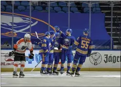  ?? ADRIAN KRAUS — THE ASSOCIATED PRESS ?? Buffalo celebrates a goal by Curtis Lazar during the first period against the Flyers in Buffalo, N.Y., on Wednesday.