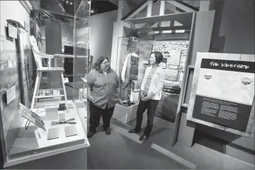  ?? @IMartensHe­rald Herald photo by Ian Martens ?? Lethbridge Historical Society president Belinda Crowson and Galt curator Aimee Benoit speak among the displays of the “Places and Traces” exhibit at the Galt Museum.