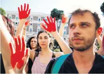  ?? PHOTO: REUTERS ?? Blood on his hands . . . Protesters outside the Interior Ministry in Rome raise redpainted hands during a demonstrat­ion against Matteo Salvini’s migrant policies earlier this month.