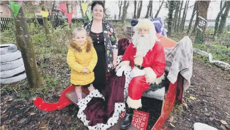  ??  ?? Teaching assistant Bev Quinn with pupil Ella Scott visit Santa Claus at the winter wonderland at Fatfield Academy, in Washington. Picture by Frank Reid