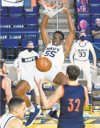  ?? PAUL W. GILLESPIE/CAPITAL GAZETTE ?? Navy’s Richard Njoku slams home a dunk late in the second half Saturday. The Midshipmen defeated the visiting Bucknell Bison 78-69.