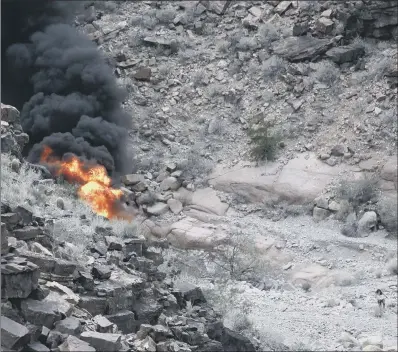  ??  ?? A woman, in the bottom right of the picture, flees the scene as the helicopter bursts into flames. CRASH INFERNO: PICTURE: TEDDY FUJIMOTO VIA AP.