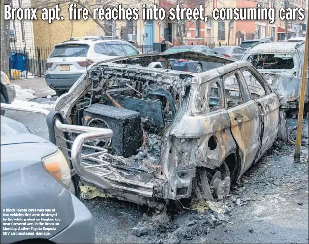  ?? ?? A black Toyota RAV4 was one of two vehicles that were destroyed by fire while parked on Hughes Ave. near Crescent Ave. in the Bronx on Monday. A silver Toyota Sequoia SUV also sustained damage.