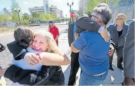  ?? RED HUBER/STAFF PHOTOGRAPH­ER ?? Noor Salman's cousin Susan Adieh, left, and other family members receive hugs from friends Friday after a jury found Salman not guilty on all charges.