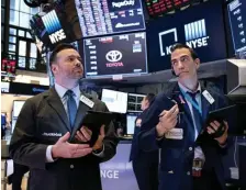  ?? AP ?? NOT A GOOD DAY: Traders Frank Masiello, left, and Gregory Rowe exchange glum looks on the floor of the New York Stock Exchange near the end of the trading day Monday.