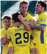  ??  ?? Three and easy: Cummins and his team-mates celebrate the final goal