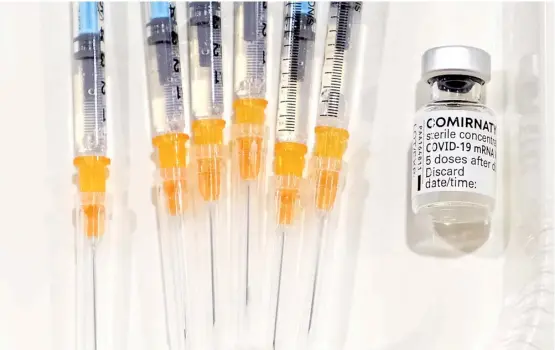  ?? KAZUHIRO NOGI/AGENCE FRANCE-PRESSE ?? VACCINE-FILLED syringes are placed beside a vial of the Pfizer-BioNTech Covid-19 vaccine in the start of a national inoculatio­n campaign against the virus at the Chiba East Hospital in Chiba.