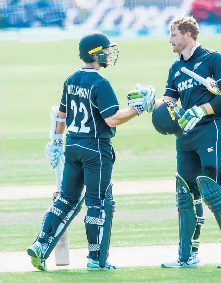  ??  ?? Black Caps opener Martin Guptill (right) celebrates his century yesterday with skipper Kane Williamson.