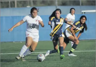  ?? Photo courtesy of Jesse Munoz ?? College of the Canyons midfielder Alondra Solis rushes to get the ball away from a Brahmas player on Saturday at COC. The Cougars eventually lost the game in penalty kicks.