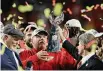  ?? Chris O'Meara/Associated Press ?? Kansas City Chiefs chairman Clark Hunt, right, hands the trophy to head coach Andy Reid after the Chiefs defeated the San Francisco 49ers in the NFL Super Bowl 54 football game in Miami Gardens, Fla.