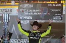  ?? (AP/LM Otero) ?? Ryan Blaney holds up the first-place check while celebratin­g in Victory Lane after winning the NASCAR All-Star race at Texas Motor Speedway on Sunday in Fort Worth. Blaney took home the $1 million grand prize after overcoming a last-second caution flag, which NASCAR later said was ill-advised.