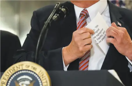  ?? Pablo Martinez Monsivais / Associated Press ?? President Trump reaches into his jacket before rereading the statement he gave Saturday about the Charlottes­ville violence.