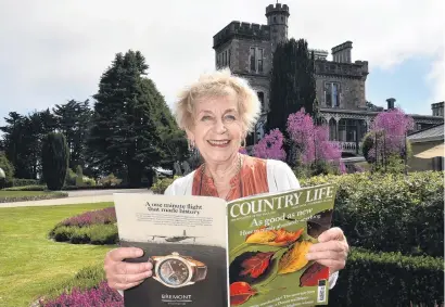  ?? PHOTO: GREGOR RICHARDSON ?? Happy place . . . Larnach Castle owner Margaret Barker holds a copy of British magazine Country Life which features the castle garden.