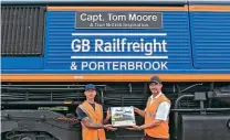  ?? Capt. Tom Moore. ?? Bachmann Collectors Club manager Gary Boyd-Hope (right) presents club member Denis Armstrong with a Pride of Britain Train Pack in front of Class 66 No. 66731