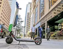  ?? [CHRIS LANDSBERGE­R, THE OKLAHOMAN] ?? One of 85 new Lime-S scooters is parked in downtown Oklahoma City on Thursday.