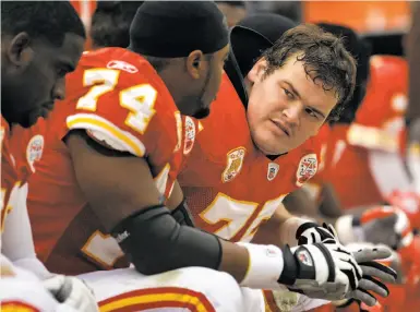  ?? Charlie Riedel / Associated Press 2009 ?? Ryan O’Callaghan, right — sitting on the Chiefs’ bench during a 2009 game — hid the fact that he is gay as he grew up in Redding and played at Cal, and once thought he would commit suicide after his football career.