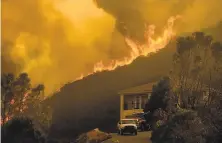  ?? Noah Berger / Associated Press ?? Flames from the River Fire threaten a home in Salinas. Fire crews across the region scrambled to contain blazes.