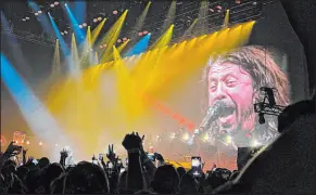  ?? Las Vegas Review-journal @Johnnykats ?? John Katsilomet­es
The intensity of Foo Fighters frontman Dave Grohl is reflected on a screen at Dolby Live on Saturday as a crowd of 5,000-plus rock with him.