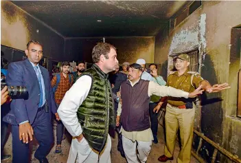  ?? — PTI ?? Congress leader Rahul Gandhi inside a private school, in the Brijpuri area that was vandalised and burnt during the riots, during his visit to one of the riot-affected areas in North-East Delhi on Wednesday. The school suffered massive damage and the delegation went around gutted classrooms and also surveyed burnt busses.