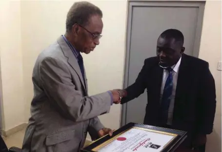  ??  ?? A former Deputy Vice-Chancellor, University of Nigeria, Enugu Campus and Chief Medical Director, Memfys Internatio­nal Hospital for Neurosurge­ry, Enugu, Prof. Sam Ohaegbulam (left) receiving the 2017 Merchant of Hope for the Medically Deprived award...