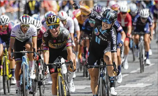  ?? PHOTOS BY MICHEL EULER/ASSOCIATED PRESS ?? Dutch rider Lorena Wiebes exults July 24 as she wins the first stage of the women’s Tour de France in Paris. Marianne Vos, also of the Netherland­s, finished second and took the overall lead with a Stage 2 victory. Many women racers said an eight-day event is a good start, but they want more.